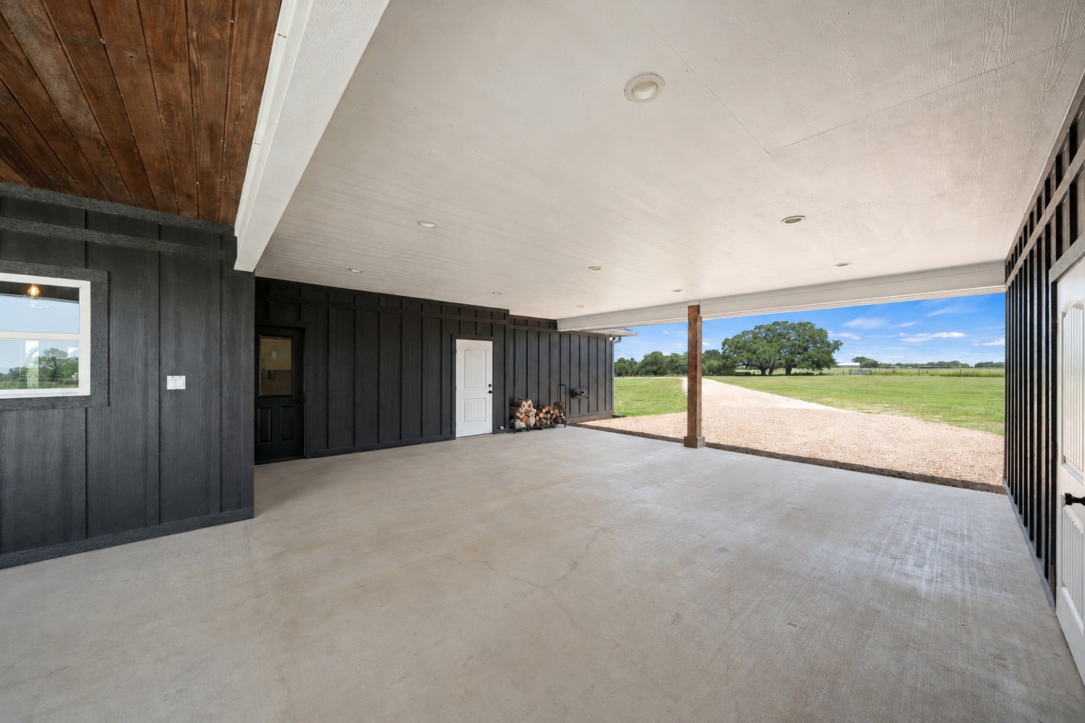 1655 Old Cuero Road Yoakum, TX 77995 - Photo 20 of 24 Virtually Cleaned: A neatly stacked firewood rack adds rustic charm, and the open-air design captures peaceful views of the surrounding countryside, making this a functional and inviting extension of the property.