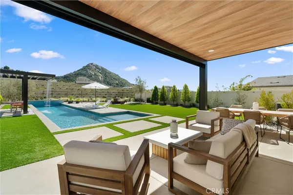 a view of a house with swimming pool and a yard