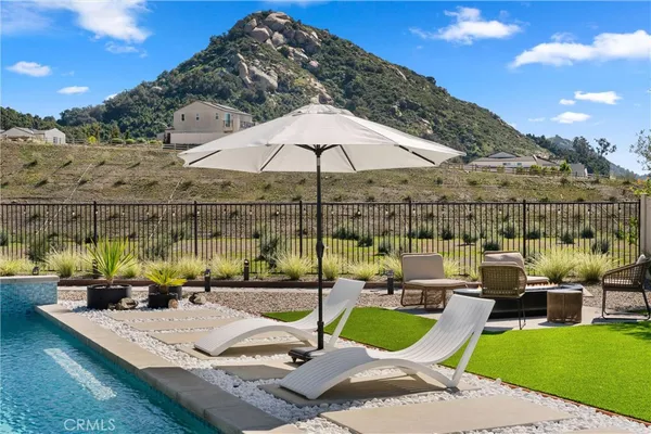 a front view of a house with garden and sitting area
