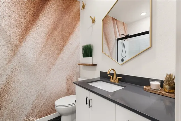 a bathroom with a double vanity sink toilet and shower