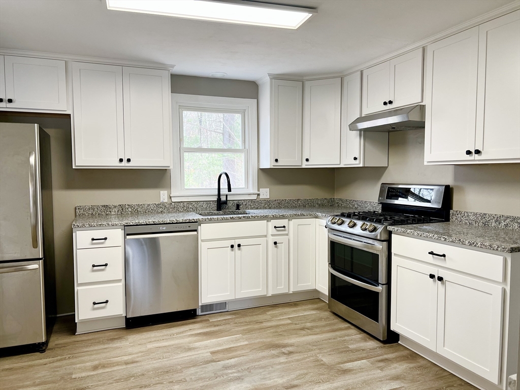 12 Sargent Lane Franklin, MA 02038 - Photo 13 of 40 a kitchen with granite countertop cabinets and stainless steel appliances