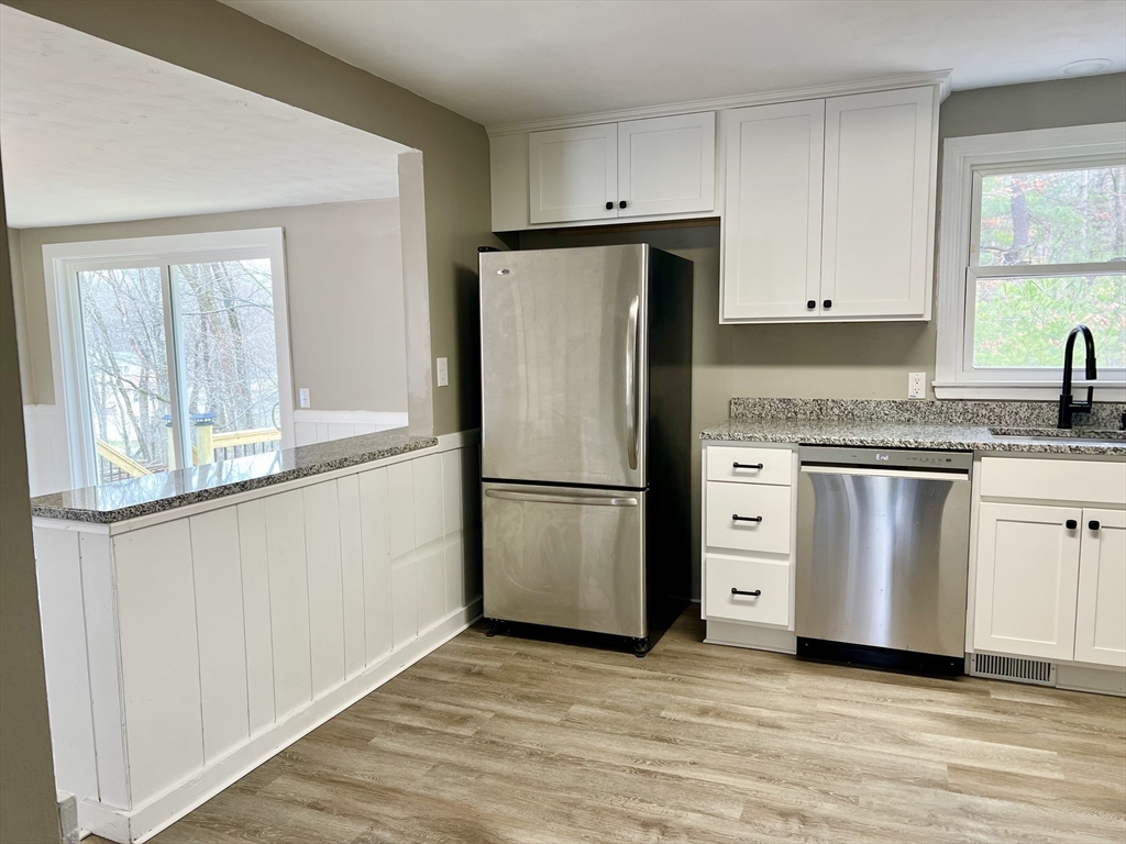 12 Sargent Lane Franklin, MA 02038 - Photo 16 of 40 a kitchen with stainless steel appliances a refrigerator sink and cabinets