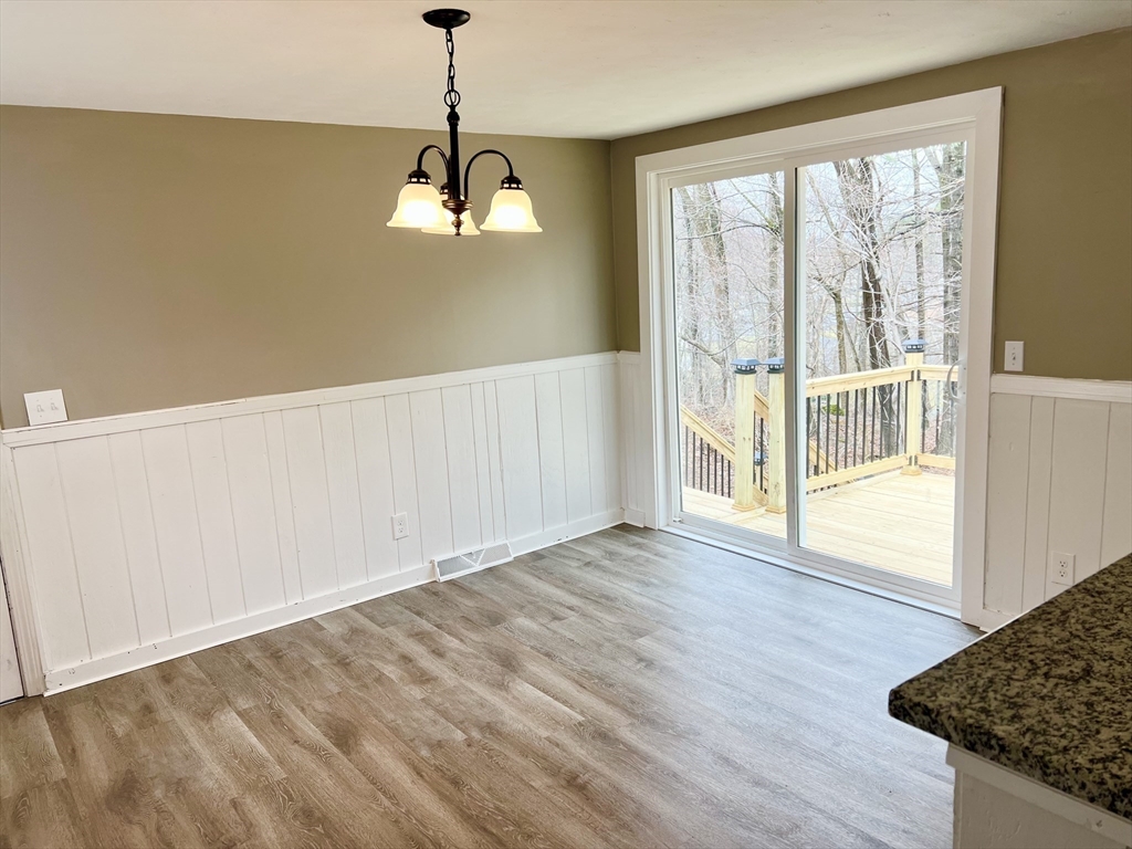 12 Sargent Lane Franklin, MA 02038 - Photo 18 of 40 a view of an empty room with wooden floor and a window