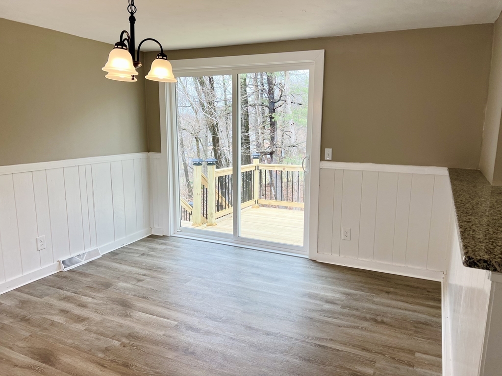 12 Sargent Lane Franklin, MA 02038 - Photo 19 of 40 a view of an empty room with wooden floor and windows