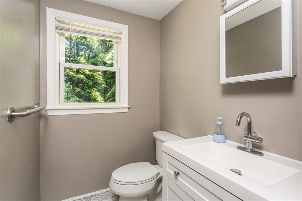 12 Sargent Lane Franklin, MA 02038 - Photo 25 of 40 a bathroom with a toilet a sink a mirror and a window