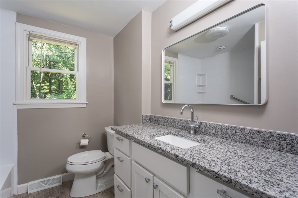 12 Sargent Lane Franklin, MA 02038 - Photo 28 of 40 a bathroom with a granite countertop toilet sink and mirror