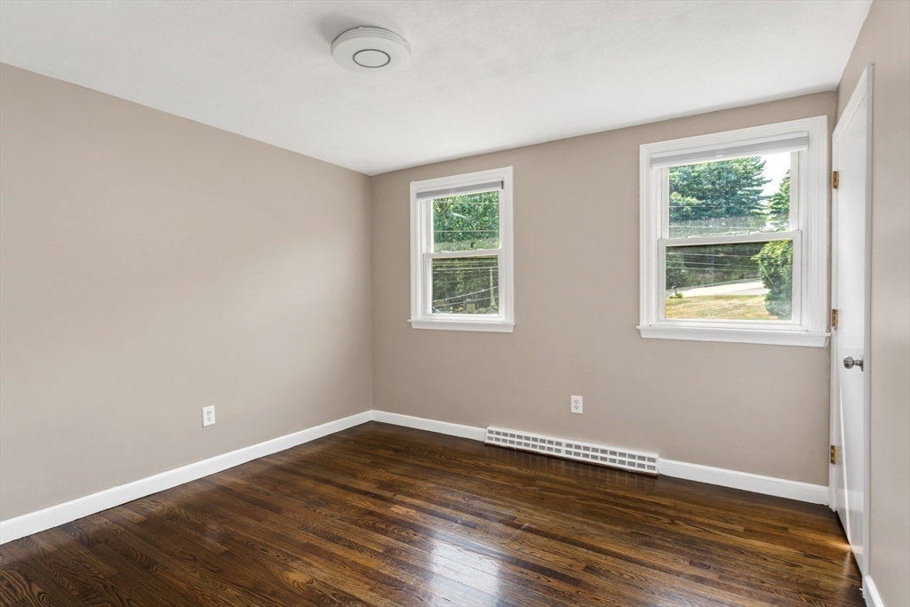 12 Sargent Lane Franklin, MA 02038 - Photo 30 of 40 a view of an empty room with wooden floor and a window