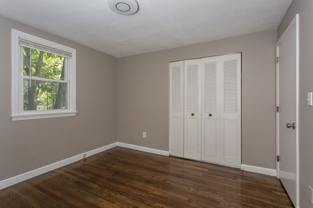 12 Sargent Lane Franklin, MA 02038 - Photo 35 of 40 a view of an empty room with wooden floor and a window
