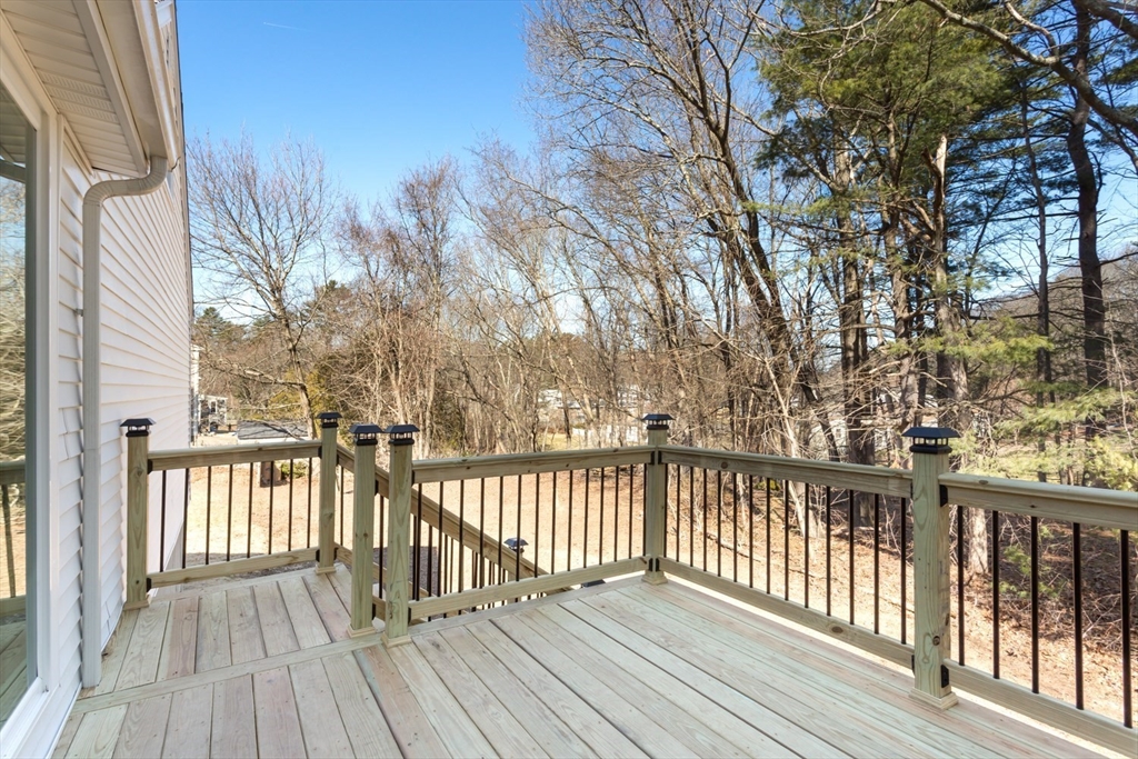 12 Sargent Lane Franklin, MA 02038 - Photo 4 of 40 a view of a wooden deck with large trees