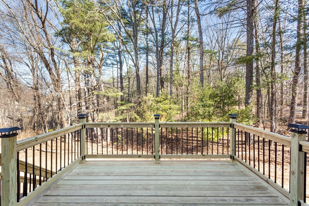 12 Sargent Lane Franklin, MA 02038 - Photo 5 of 40 a view of a balcony with wooden floor and fence