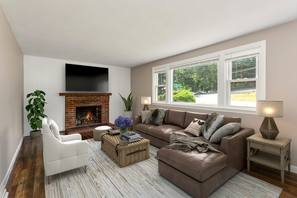12 Sargent Lane Franklin, MA 02038 - Photo 8 of 40 a living room with furniture a flat screen tv and a fireplace