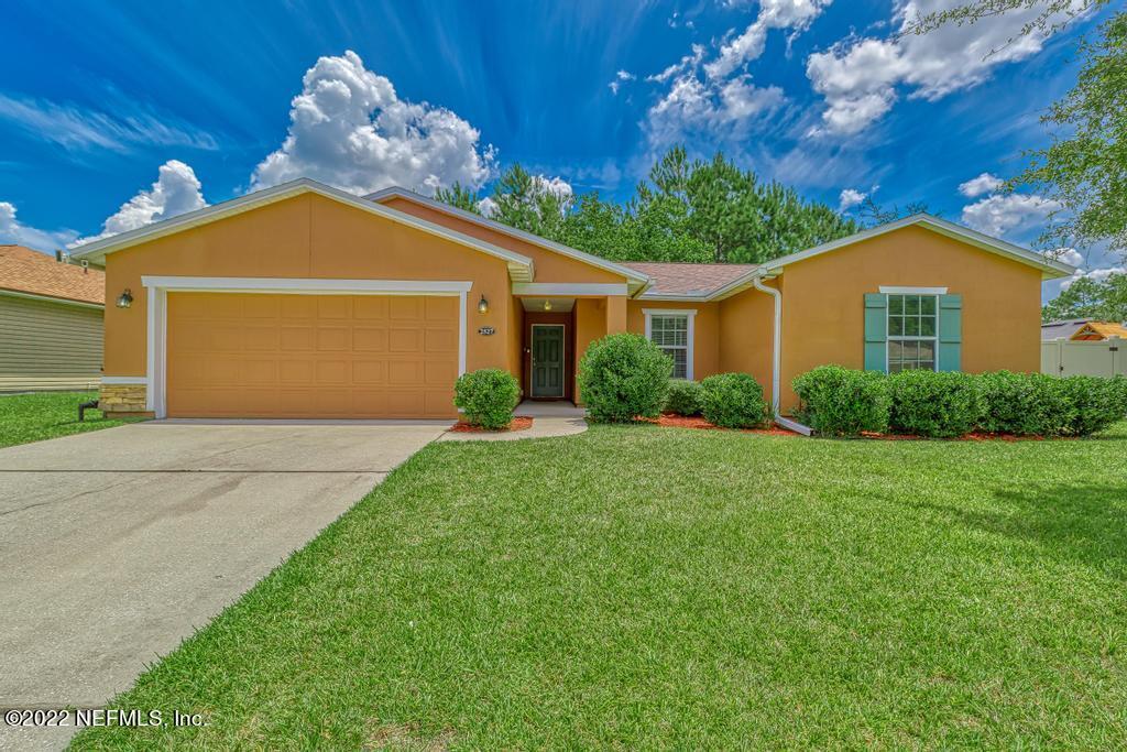 a front view of house with yard and green space