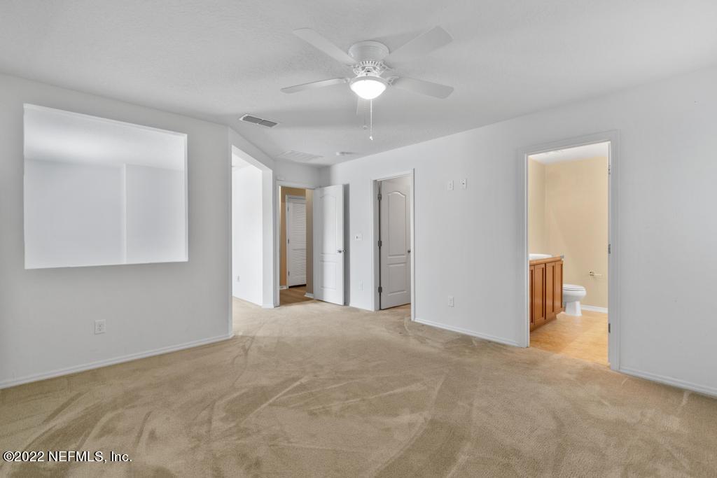 2527 Eisner Drive Jacksonville, FL 32218 - Photo 13 of 29 a view of a big room with closet and a chandelier fan