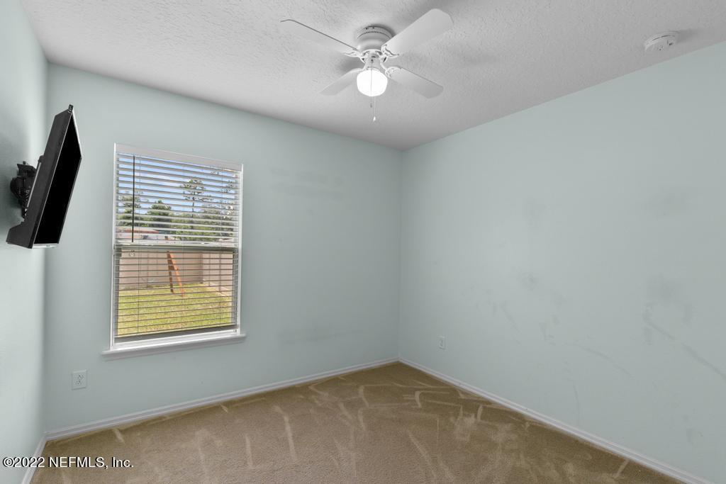 2527 Eisner Drive Jacksonville, FL 32218 - Photo 19 of 29 an empty room with windows and fan