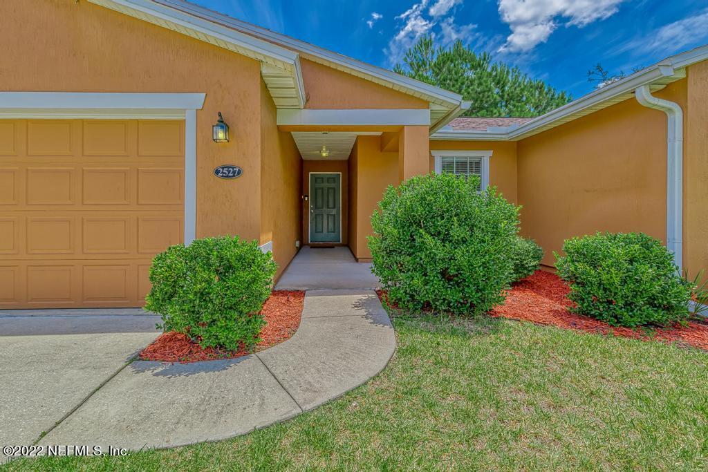 2527 Eisner Drive Jacksonville, FL 32218 - Photo 2 of 29 a view of a backyard with potted plants
