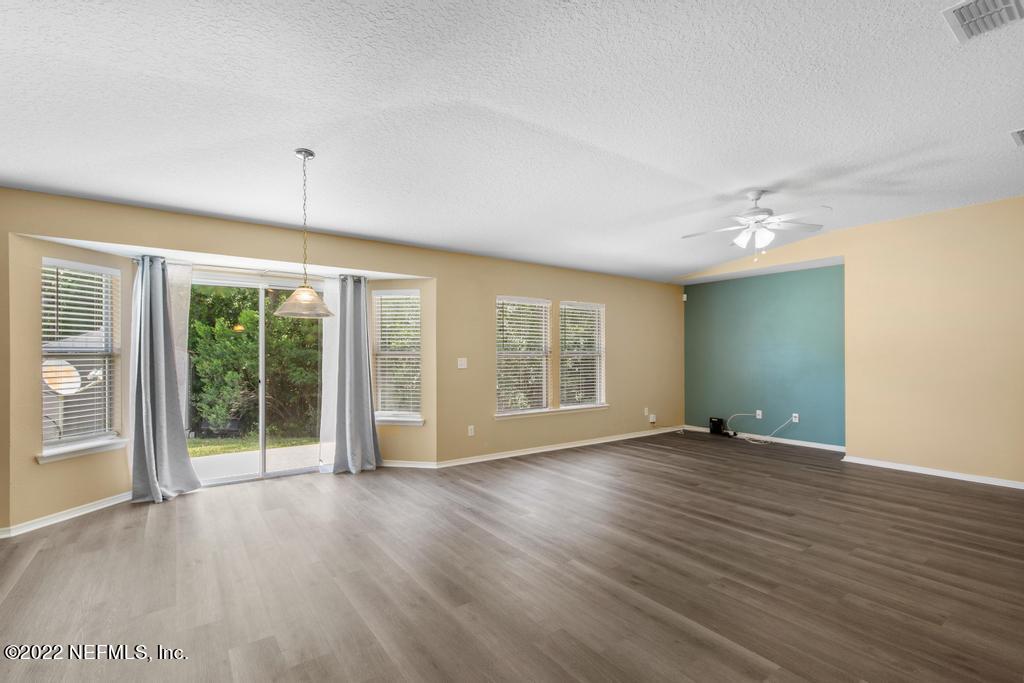 2527 Eisner Drive Jacksonville, FL 32218 - Photo 7 of 29 a view of an empty room with a window and wooden floor