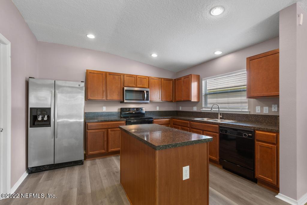 2527 Eisner Drive Jacksonville, FL 32218 - Photo 10 of 29 a kitchen with stainless steel appliances granite countertop a sink stove and refrigerator