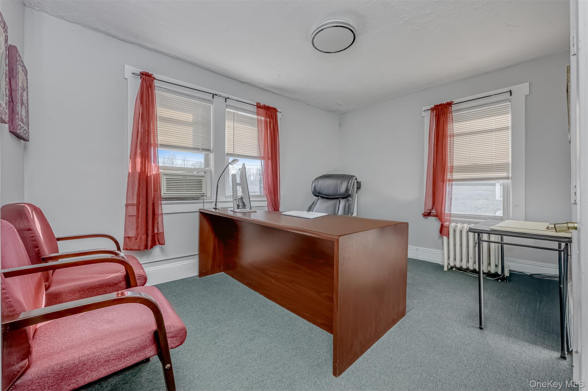 313 North Main Street Spring Valley, NY 10977 - Photo 14 of 19 Carpeted office with radiator heating unit and healthy amount of natural light