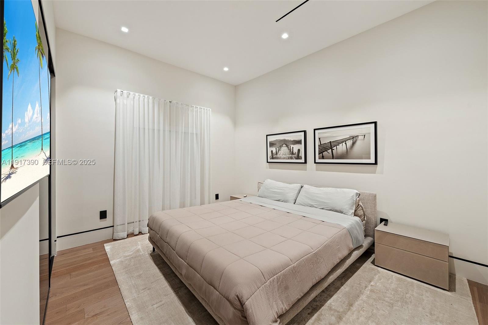 900 Washington Street Hollywood, FL 33019 - Photo 16 of 61 a bedroom with a large bed and a chandelier