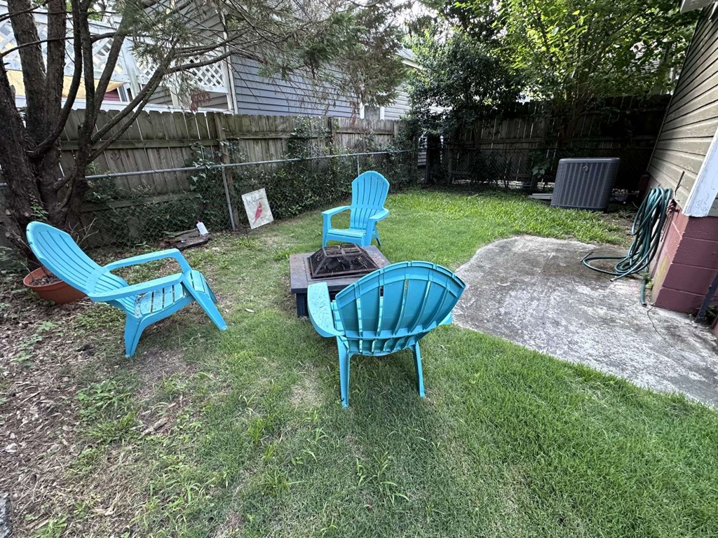443 2nd Avenue Columbus, GA 31901 - Photo 20 of 20 a view of a backyard with table and chairs potted plants and a large tree