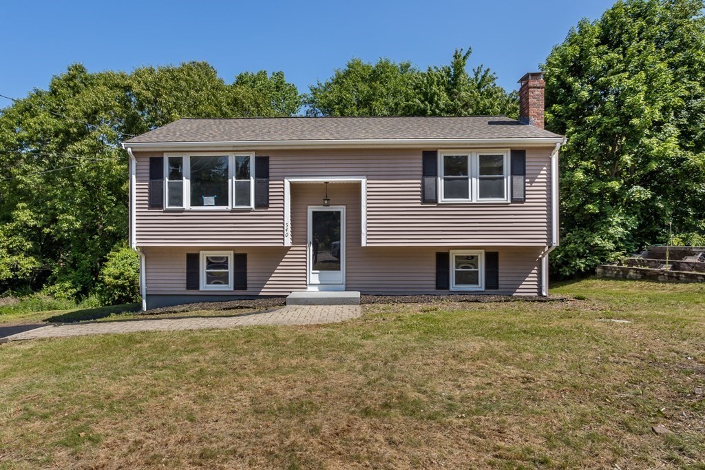 a house with lots of trees in the background