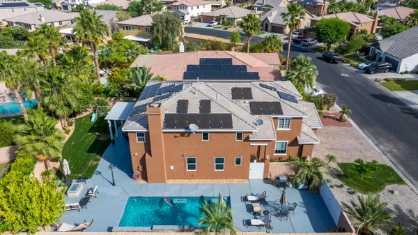an aerial view of a house with a yard