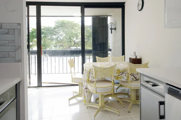 a kitchen with stainless steel appliances kitchen island granite countertop a sink and a refrigerator