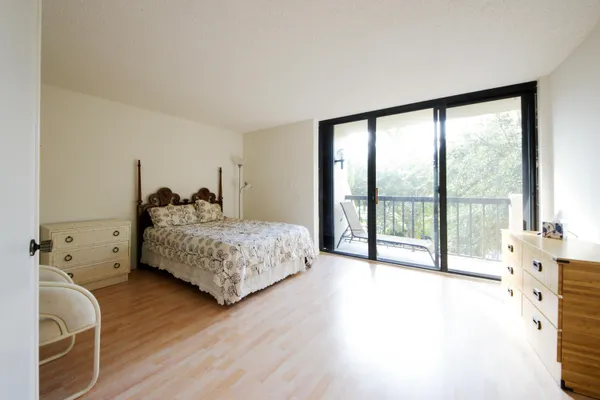 a bedroom with a large bed and a large window