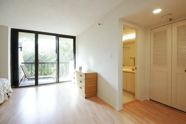 a spacious bedroom with a large bed and a large window