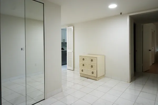 a large white kitchen with granite countertop a sink and dishwasher with a large window
