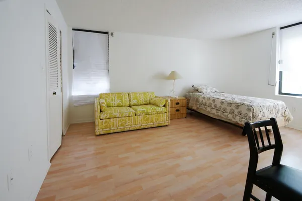 a bathroom with a shower a sink and toilet