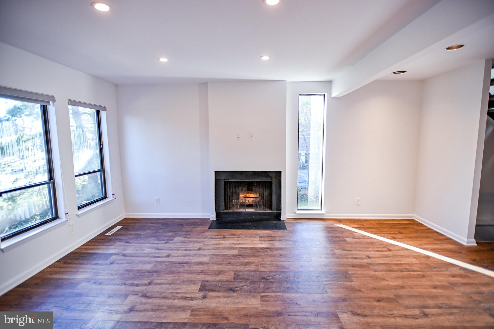 733 Stoney Spring Drive Baltimore, MD 21210 - Photo 15 of 53 Living room w/ wood burning fireplace