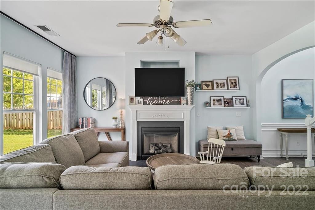 244 Sand Paver Way, Unit 60 Fort Mill, SC 29708 - Photo 11 of 42 a living room with furniture a fireplace and a flat screen tv