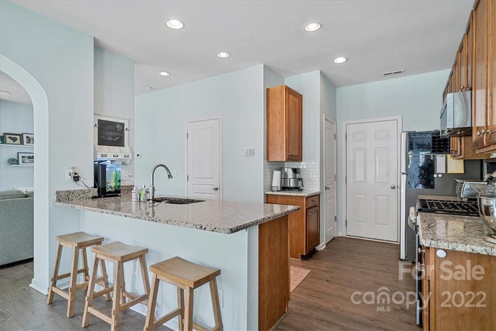 244 Sand Paver Way, Unit 60 Fort Mill, SC 29708 - Photo 16 of 42 a kitchen with stainless steel appliances granite countertop a sink and a refrigerator