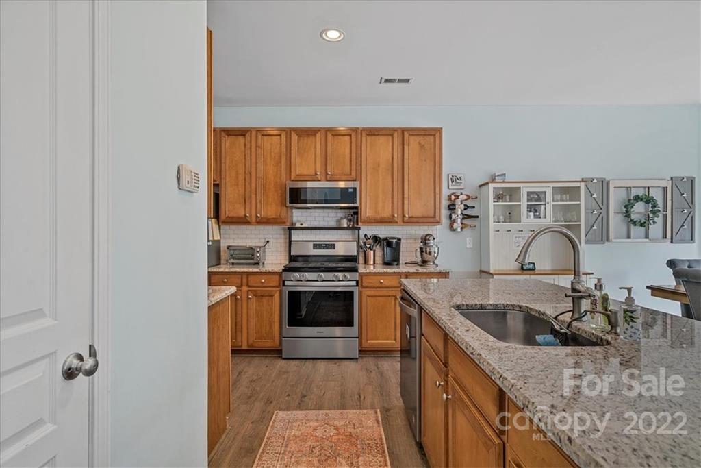 244 Sand Paver Way, Unit 60 Fort Mill, SC 29708 - Photo 18 of 42 a kitchen with a sink a stove and refrigerator