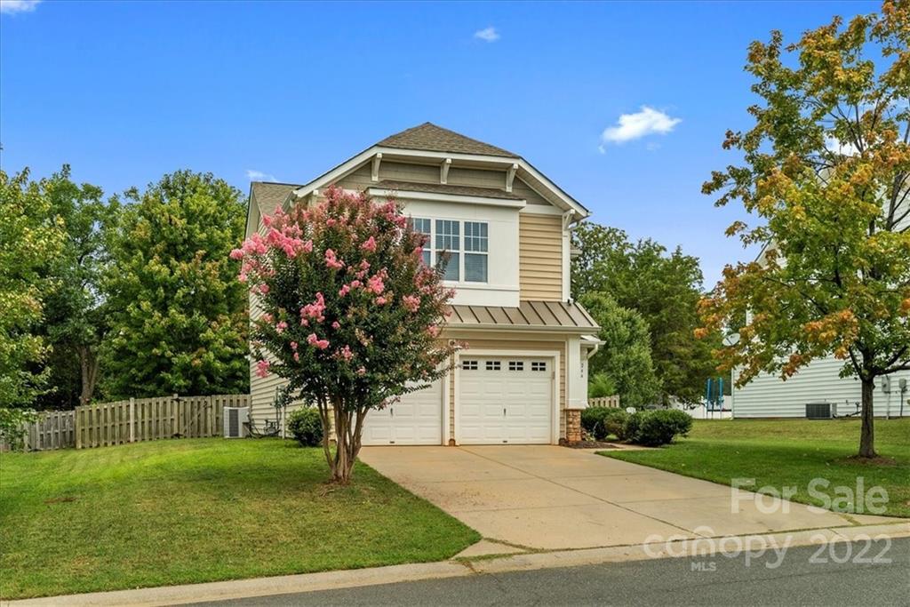 244 Sand Paver Way, Unit 60 Fort Mill, SC 29708 - Photo 2 of 42 a front view of a house with garden