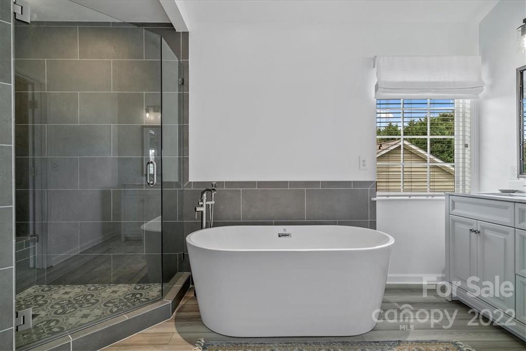 244 Sand Paver Way, Unit 60 Fort Mill, SC 29708 - Photo 25 of 42 a white bath tub sitting in a bathroom next to a window