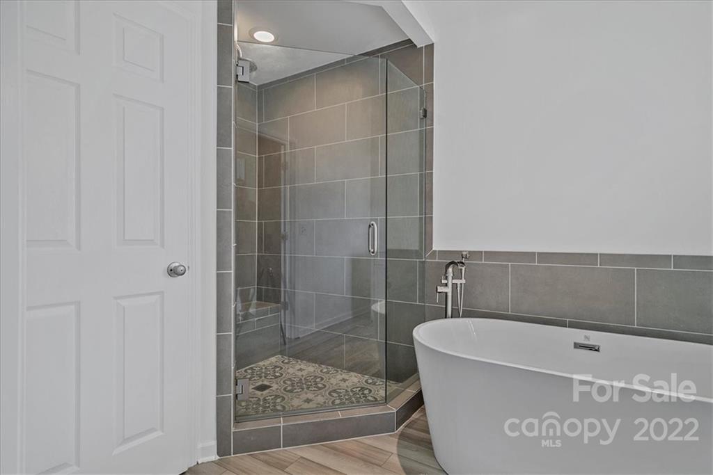 244 Sand Paver Way, Unit 60 Fort Mill, SC 29708 - Photo 26 of 42 a bathroom with a bathtub and shower