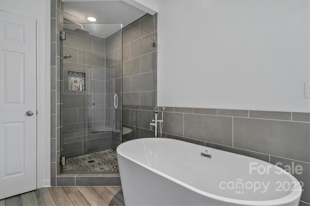 244 Sand Paver Way, Unit 60 Fort Mill, SC 29708 - Photo 27 of 42 a bathroom with a bathtub and shower