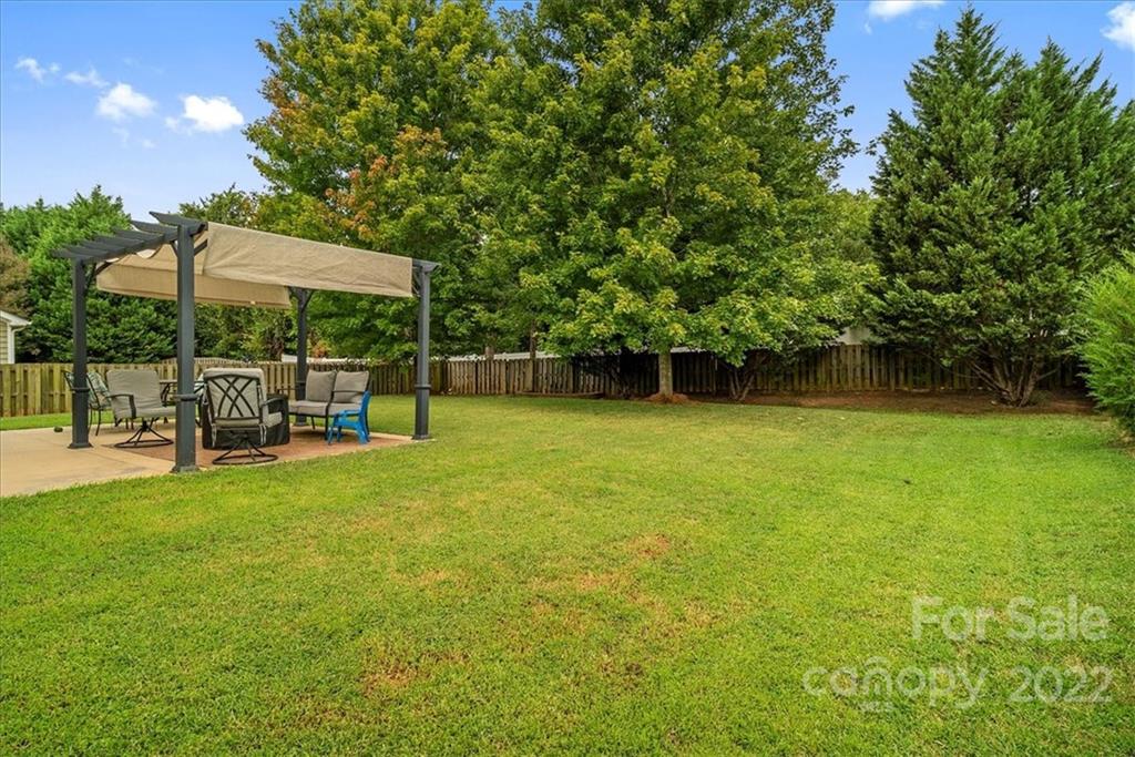 244 Sand Paver Way, Unit 60 Fort Mill, SC 29708 - Photo 36 of 42 a view of a chair and table on the garden