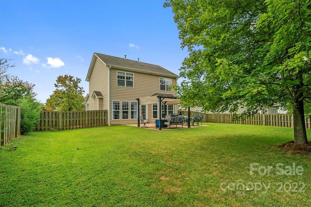 244 Sand Paver Way, Unit 60 Fort Mill, SC 29708 - Photo 38 of 42 a view of a house with a yard and sitting area