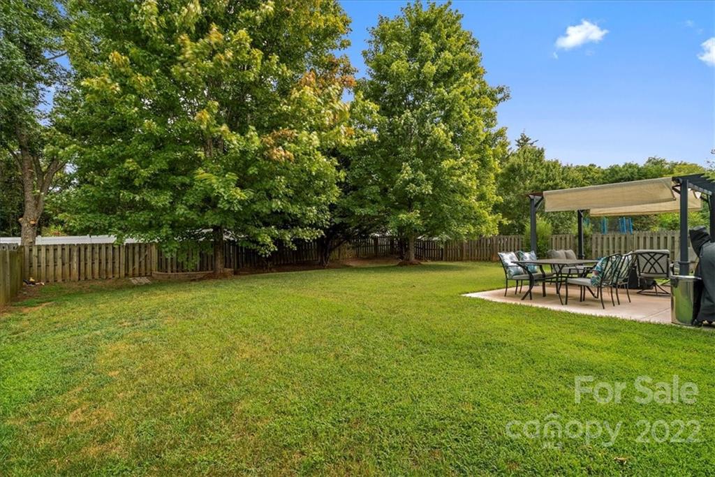 244 Sand Paver Way, Unit 60 Fort Mill, SC 29708 - Photo 41 of 42 a view of a chair and table on the garden