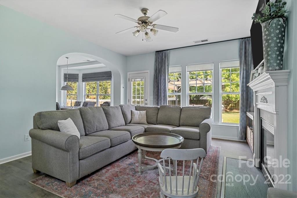 244 Sand Paver Way, Unit 60 Fort Mill, SC 29708 - Photo 7 of 42 a living room with furniture a large window and a fireplace