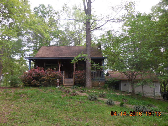 4061 Johnstonville Road Forsyth, GA 31029 - Photo 1 of 8 front view of a house with a garden