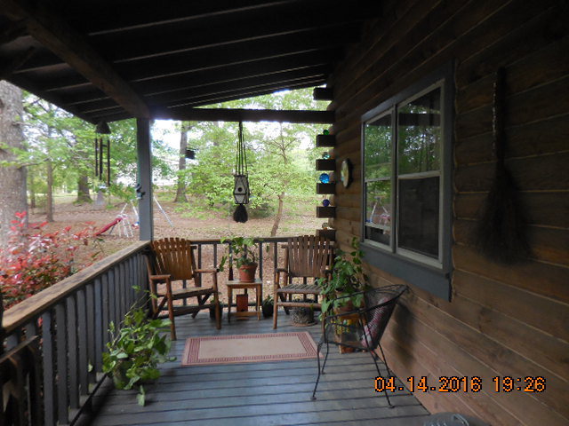 4061 Johnstonville Road Forsyth, GA 31029 - Photo 3 of 8 a view of a balcony with chairs and wooden floor