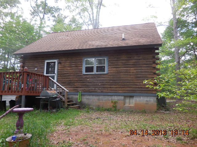 4061 Johnstonville Road Forsyth, GA 31029 - Photo 8 of 8 a view of a small house in front of a yard with plants and large tree