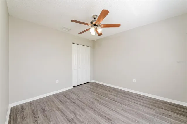 a view of an empty room with wooden floor