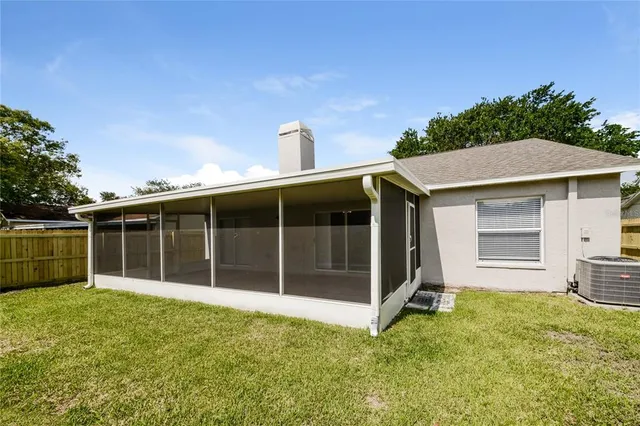 a view of house with backyard and shower