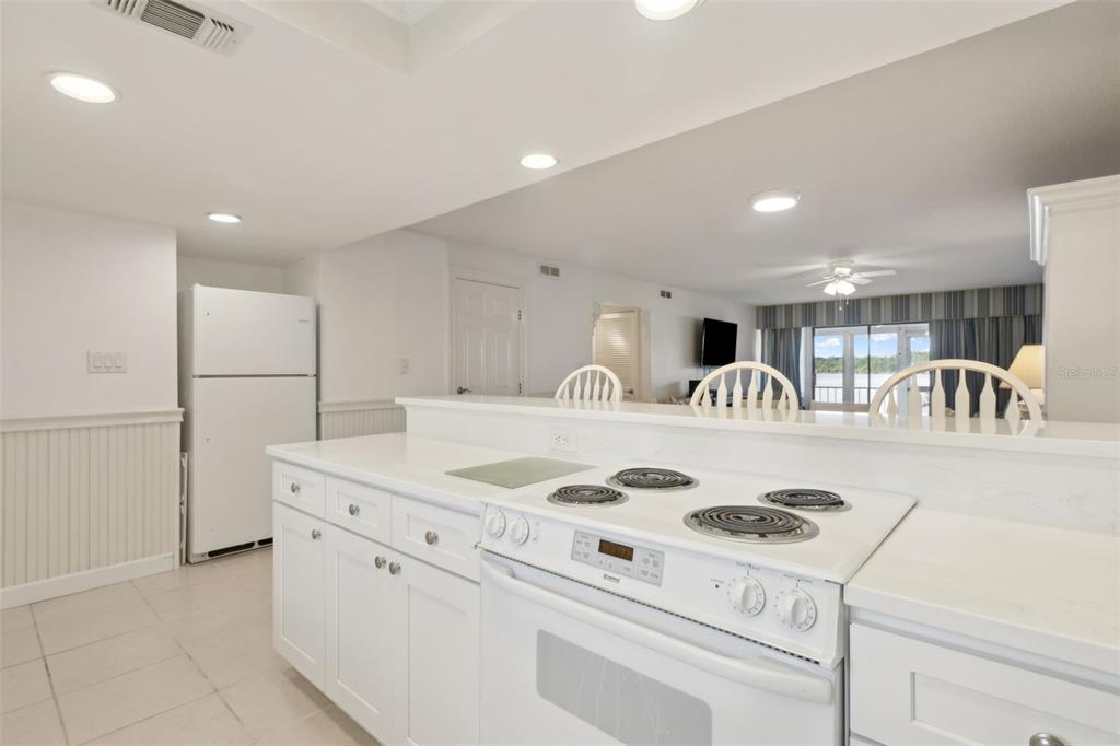 125 River Bend Road, Unit D Welaka, FL 32193 - Photo 12 of 53 a kitchen with kitchen island a stove a sink and a refrigerator