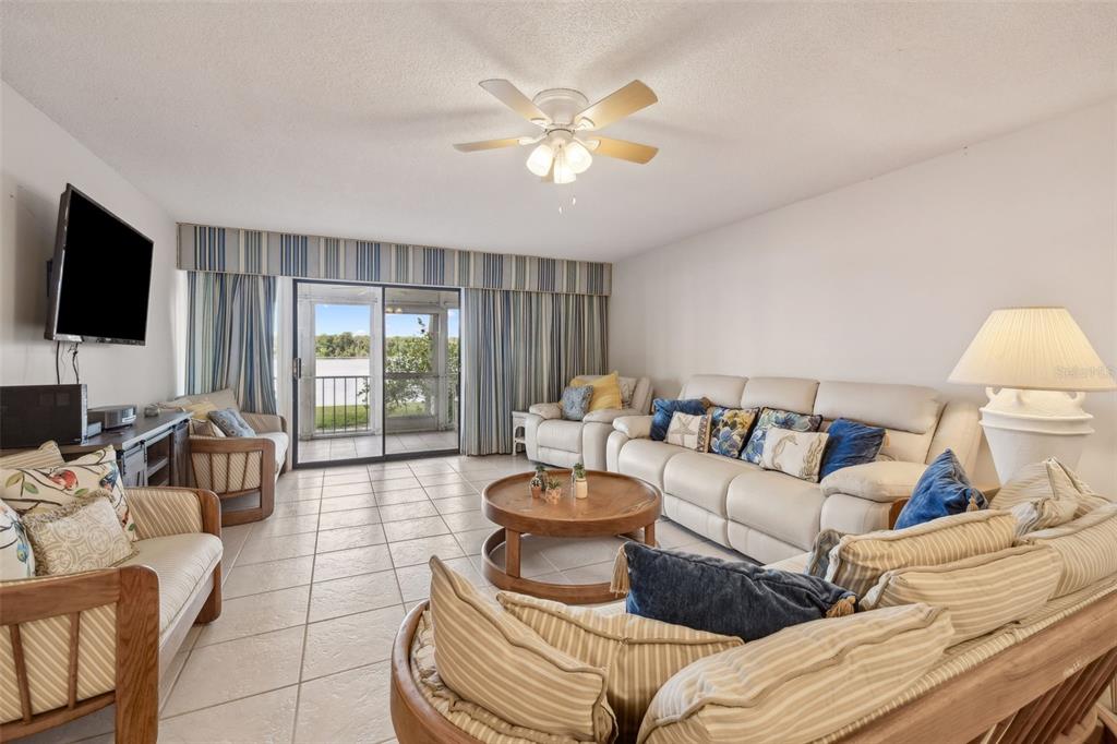 125 River Bend Road, Unit D Welaka, FL 32193 - Photo 15 of 53 a living room with furniture and a flat screen tv